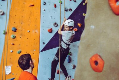 Ragazzo scala una parete boulder